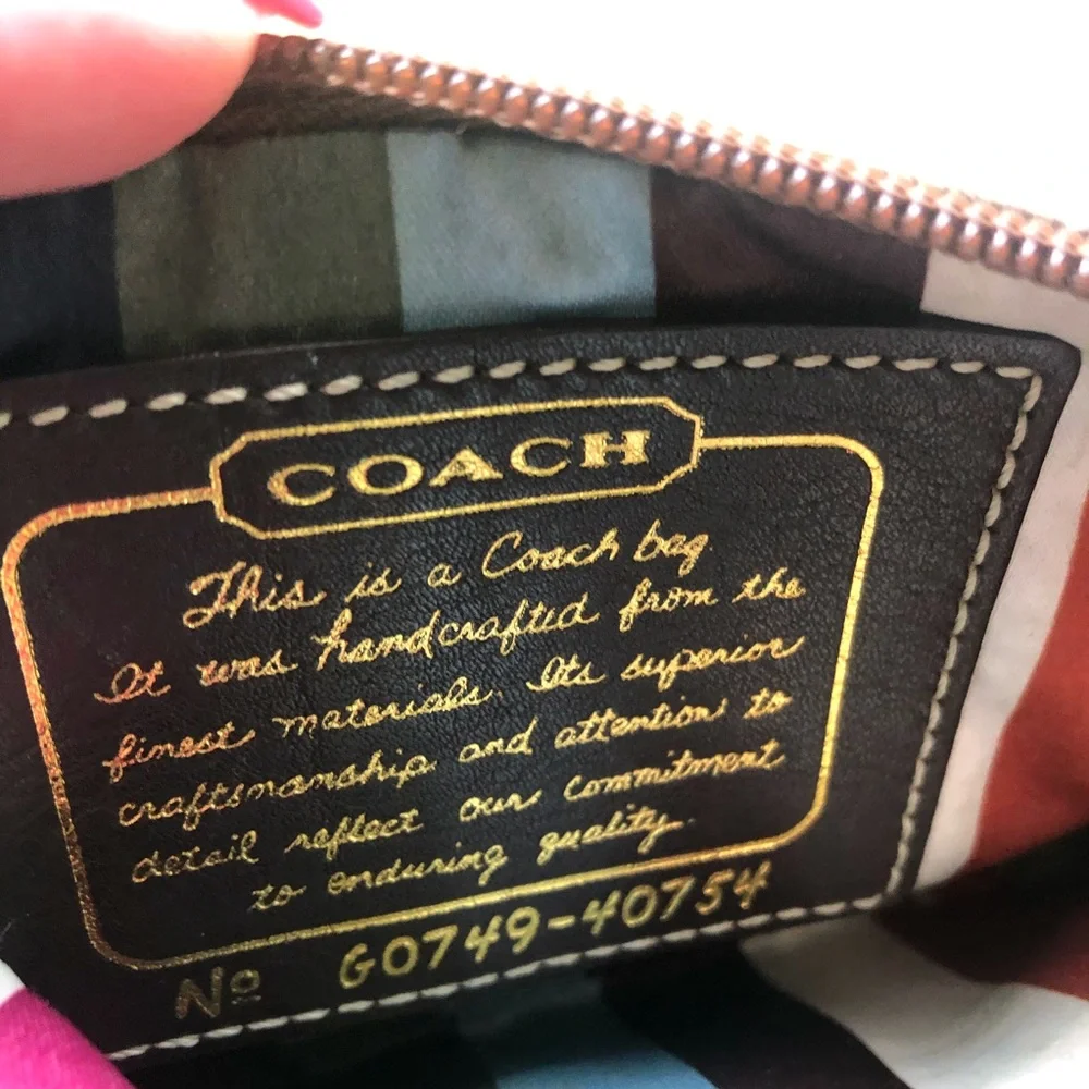 Coach signature tan wristlet, gold strap & stripe
